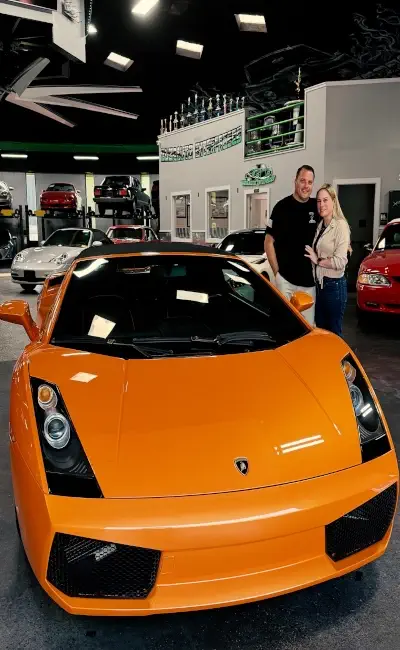 Happy customer with exotic car at Buonauto Enterprises dealership