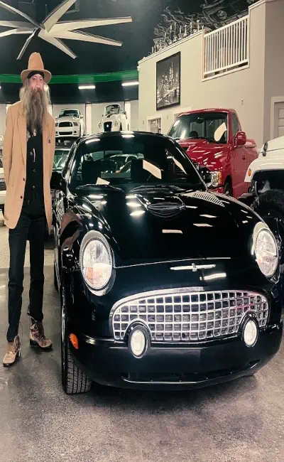 Customer standing proudly with newly purchased exotic vehicle